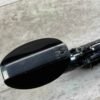 Vintage motorcycle handlebar with a focus on the metal clamp and screw, showcasing classic bike details at Checkpoint Charlie's in Berlin, a historic site with iconic Cold War significance.