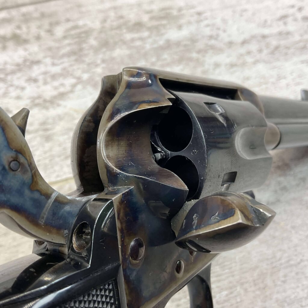 M1911 revolver with a broken barrel showing the internal chambers, close-up view. A detailed image highlighting the firearm's design and mechanical components, ideal for firearm enthusiasts and collectors.