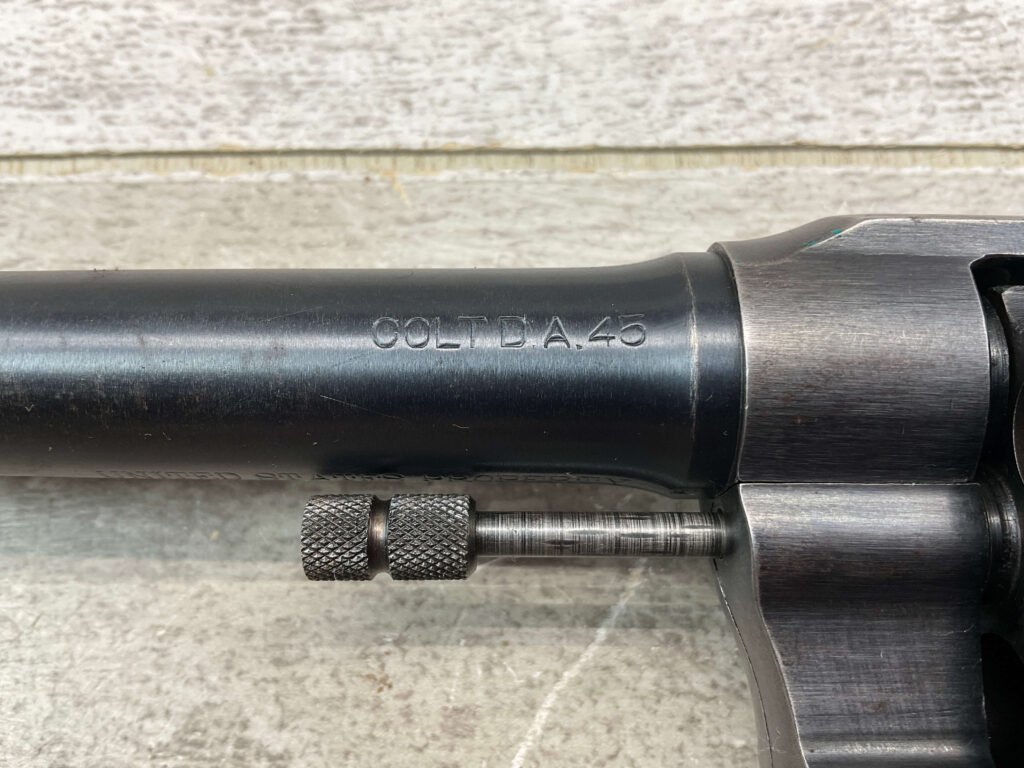 Vintage Colt D.A. 45 revolver barrel close-up, showcasing the engraved weapon details and firearm craftsmanship. Perfect for firearm enthusiasts and collectors interested in historical guns.