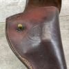 Vintage leather holster with embossed Checkpoint Charlie emblem, historical Berlin military artifact, showcasing Berlin Wall history and Cold War era memorabilia.