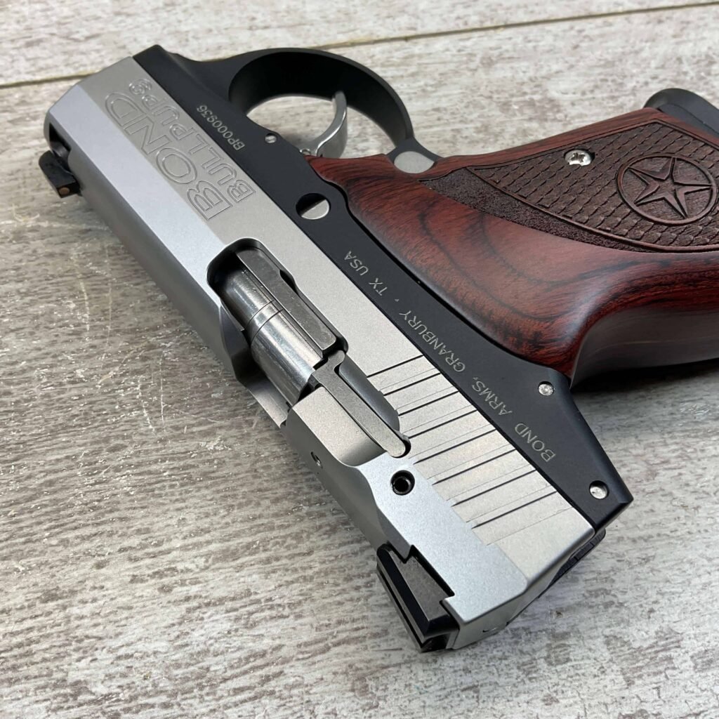 5. A close-up image of a silver and black Browning 1911 handgun with a wooden grip, placed on a light wooden surface, showcasing its detailed design and craftsmanship.