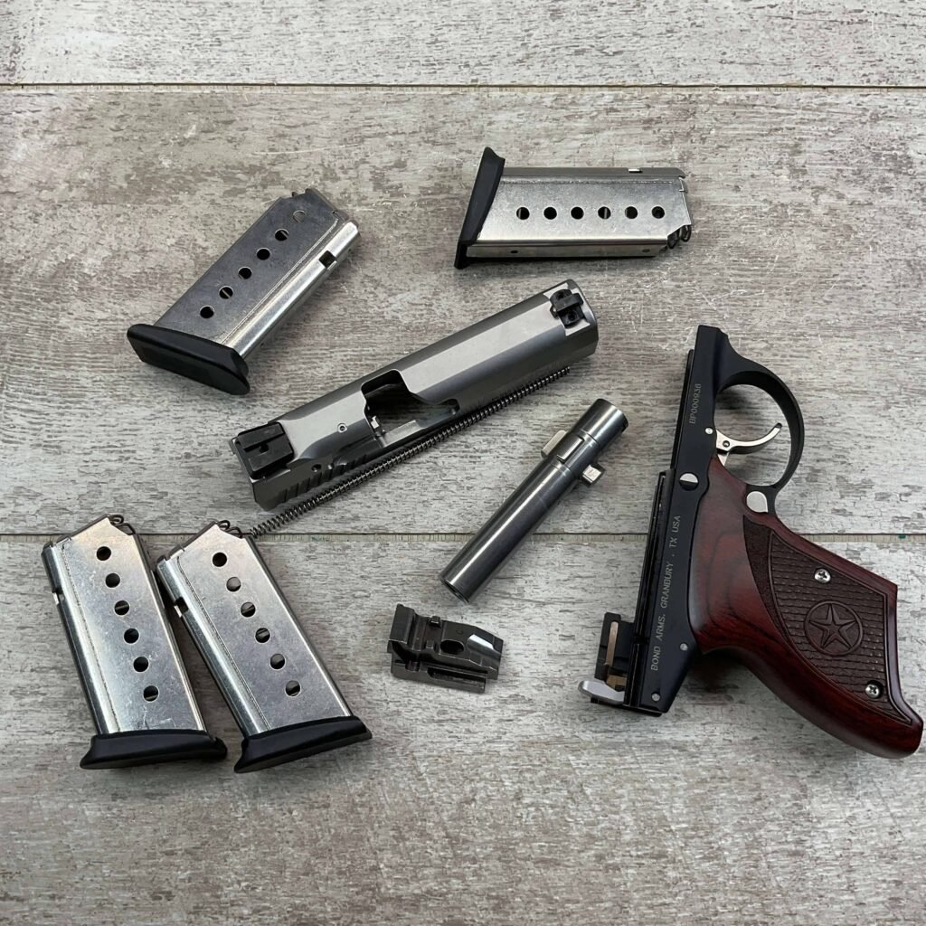 Loaded handgun and magazines on wooden surface for security and firearm safety awareness.