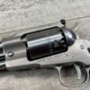4. A close-up image of a silver Ruger Old Army revolver with "Black Powder Only" engraved on the cylinder, resting on a wooden surface, showcasing its metallic finish and detailed craftsmanship.